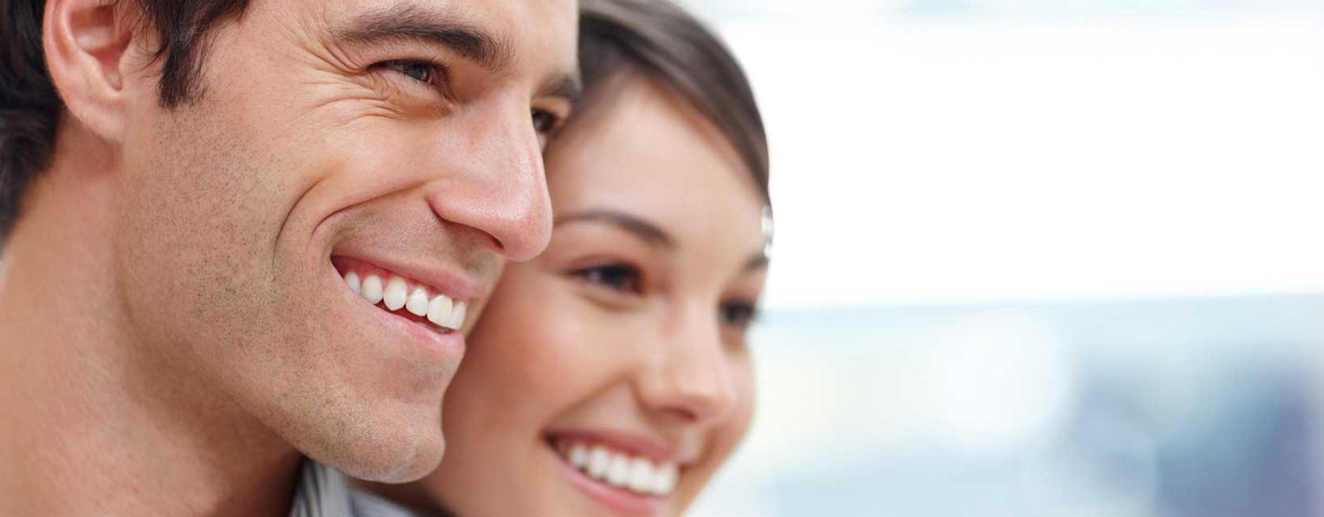 Smiling man and woman with healthy teeth