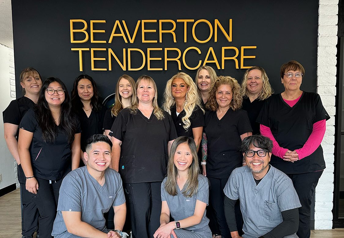 The Beaverton TenderCare team in front of the office sign